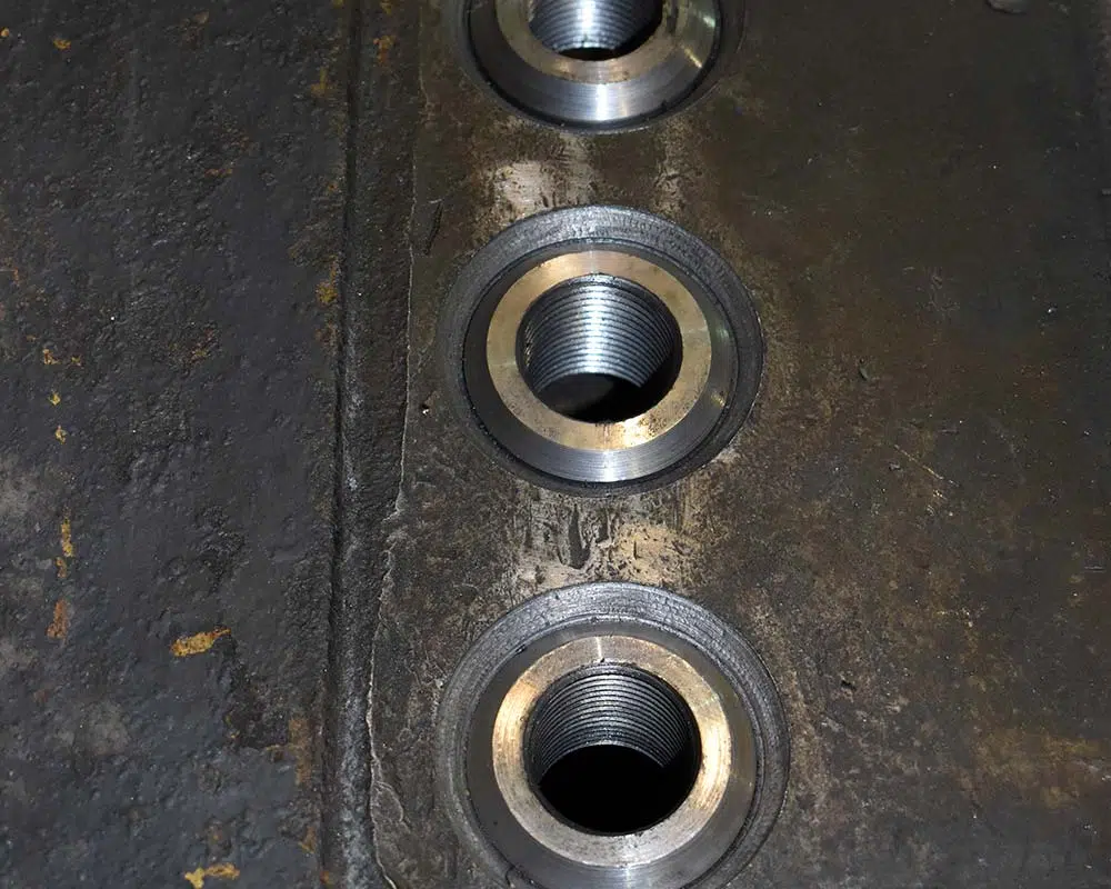 Threaded Inserts Pressed Into Bored Holes Before Welding